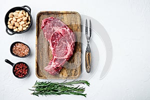 Raw fresh meat Ribeye steak entrecote of Black Angus Prime meat with ingredients, on white stone  background, top view flat lay,