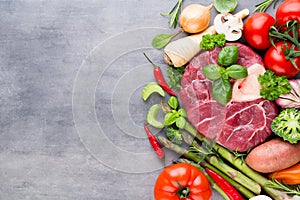 Raw fresh meat Ribeye Steak with vegetables and spice.