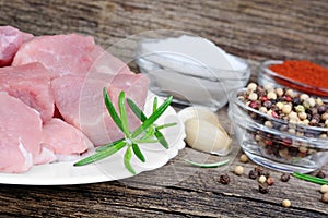 Raw fresh meat with spices on a old wood background