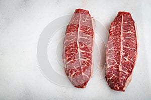 Raw fresh meat Top Blade steaks on light background. top view with copy space