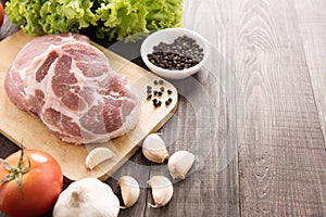 Raw fresh meat and vegetable on wooden background