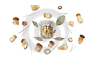 Raw fresh mushrooms Boletus edulis and marinated in glass jar, spices, bay leaf, garlic, on a white background. Top view, flat lay