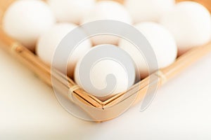 Raw fresh organic eggs in wicker plate on white background. Ingredient of healthy eating