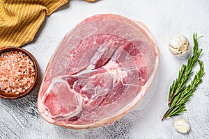 Raw fresh pork ham cut. Leg meat. Gray background. Top view