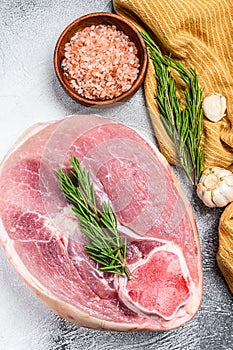 Raw fresh pork ham cut. Leg meat. Gray background. Top view