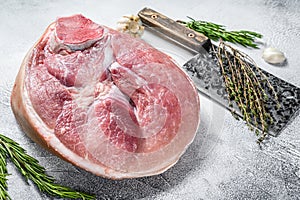 Raw fresh pork ham cut. Leg meat. Gray background. Top view