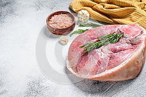 Raw fresh pork ham cut. Leg meat. Gray background. Top view. Copy space