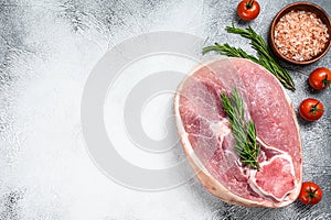 Raw fresh pork ham cut. Leg meat. Gray background. Top view. Copy space