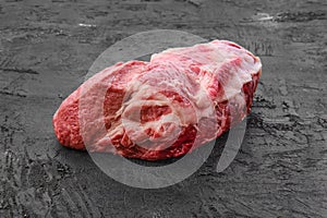 Raw fresh pork leg joint meat on black