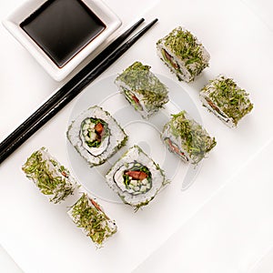 Raw fresh sushi roll with soy sauce in white plate, Japanese food style