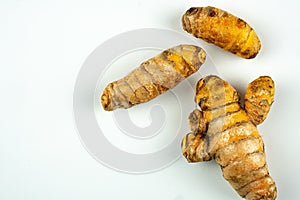 Raw fresh tumeric on white background with copyspace