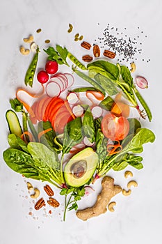 Raw fresh vegetables, fruits, berries, nuts on a white background. Healthy food background, top view. Go vegan concept.