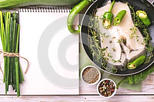 Raw fresh white fish steak with vegetables ingredients