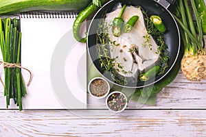 Raw fresh white fish steak with vegetables ingredients