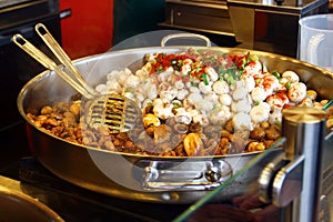 Raw and fried champignons in a frying pan