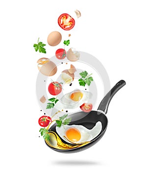 Raw and fried eggs with tomatoes and parsley are falling into a frying pan with oil isolated on white background