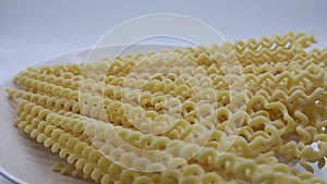 Raw Fusilli Lunghi Bucati. Traditional italian pasta on rotating display.