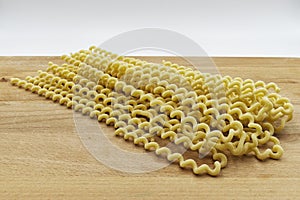 Raw Fusilli Lunghi Bucati. Traditional italian pasta on wooden table.