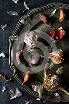 Raw garlic on grey pewter plate