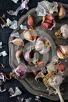 Raw garlic on grey pewter plate