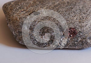 Raw garnet, semi-precious stone on rock