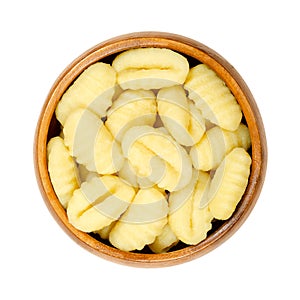 Raw gnocchi, Italian dumplings made of potatoes and flour, in wooden bowl