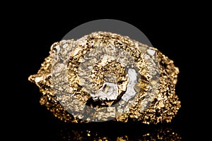 Raw golden iron pyrite mineral stone in front of black background