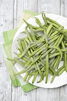 Raw green beans (Phaseolus vulgaris) on plate