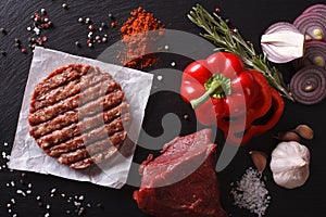 Raw Ground beef Burger steak cutlets with ingredients. horizontal top view