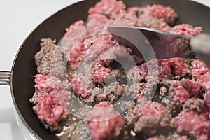 Raw ground beef with lots of grease in kitchen