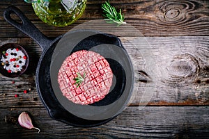 Raw ground beef meat burger steak cutlets in frying pan