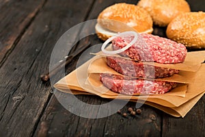 Raw ground beef meat burger steak cutlets on wooden table