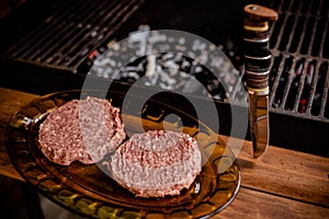 Raw ground beef meat hamburger patties on paper, dry pepper.raw beef or pork meat barbecue burgers for hamburger cooked