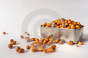 Raw Groundnuts in an earthen bowl on white background.