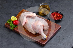 Raw half chicken with skin