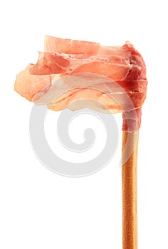 Raw ham rolled up on a breadstick
