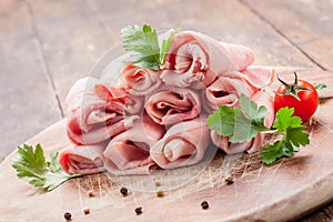 Raw Ham rolls on wooden table