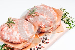 Raw Hamburger,meatballs on white background. fast food at home.Convenience food, precooked.Raw chicken burger on a white plate in