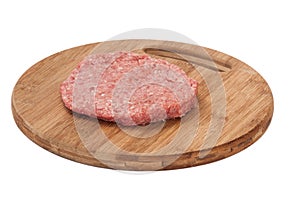 Raw hamburger on wooden board prepared for roasting