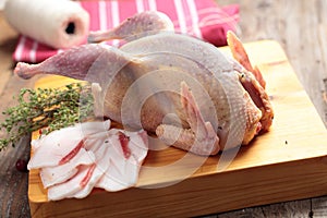 Raw Hazel Grouse on a chopping board