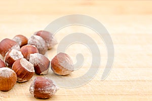 Raw hazelnuts, pecan nuts and chestnuts on a wooden background. Oleaginous