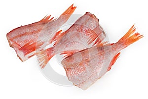 Raw headless gutted carcasses of redfish on a white background