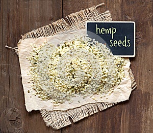 Raw hemp seeds with small chalkboard