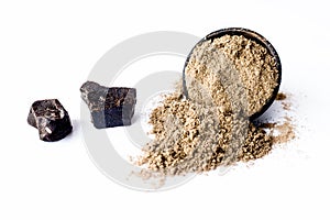 Raw hing or asofoetida or devil`s dung isolated on white with its power also.