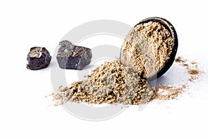 Raw hing or asofoetida or devil`s dung isolated on white with its power also.