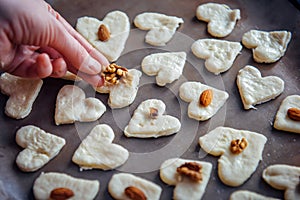 Raw homemade heart-shaped cookies on a baking sheet. Concept of fresh pastry, surprise for Valentine`s day