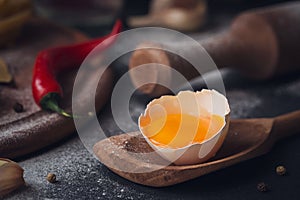 Raw homemade pasta with flour and spices on the rustic background.