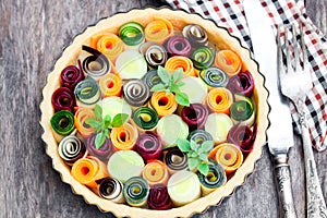 Raw homemade vegetarian pie with colored vegetables. Ready for