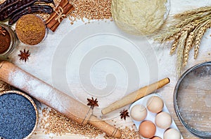 Raw igredients for cooking bread or cake eggs, spices, flour, rolling pin, sieve. Baking background with copy space for text