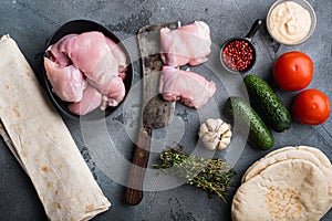 Raw ingredients, chicken meat on grey backgroundtop view